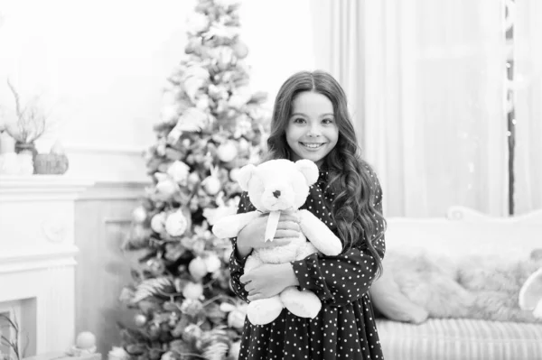 delivery christmas gifts. happy little girl celebrate winter holiday. christmas time. happy new year. Cute little child girl with xmas present. best present ever. Have a holly jolly Christmas