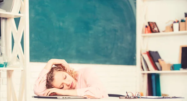 Tired tutor fall asleep at workplace. Tired student lean on desk. Exhausting lesson. Woman tired in school classroom. Teacher exhausted after hard working day. School pedagogue stressful occupation