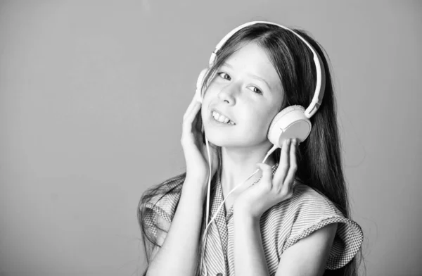 study language. home schooling. small girl pupil in headphones. self education. Mp3 player. girl listen to music. Audio book. back to school. child study online. E learning with ebook