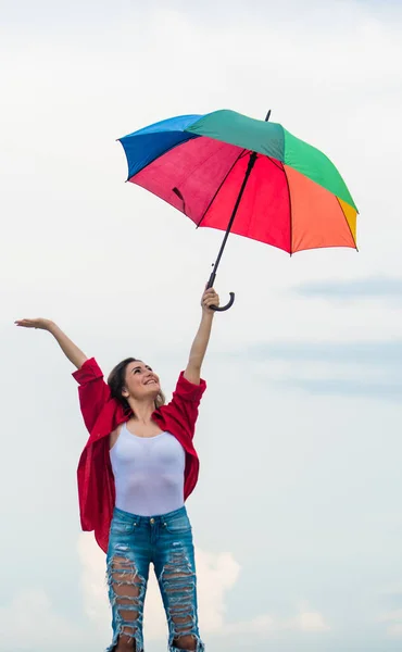 Good mood at any weather. autumn weather forecast. carefree time spending. autumn fashion. Rainbow umbrella protection. rainy weather. Fall positive mood. pretty woman with colorful umbrella