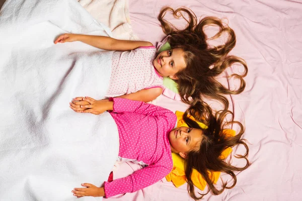 Kindheits- und Morgenkonzept. Kinder in rosa Pyjamas — Stockfoto