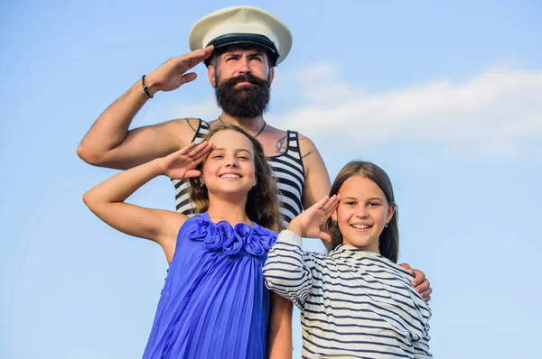 ship captain salute. welcome on board. small girls marine fashion. parenting discipline. sea cruise. have good swim. bearded sailor with kids. father back home. family day. dad and daughters outdoor