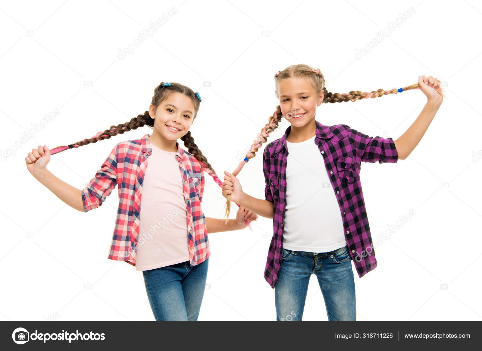 Doing cute and easy hair style. Happy children hold long braided hair style.  Small girls smile in casual fashion style. Keep your style. Fashion and  beauty. Hair salon Stock Photo by ©stetsik
