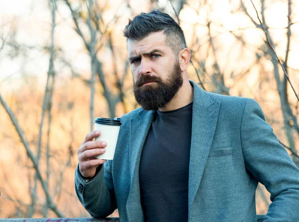 Caffeine gives him energy. Bearded man enjoy coffee in autumn morning. Businessman hold cup of hot energy drink. Being charged with energy