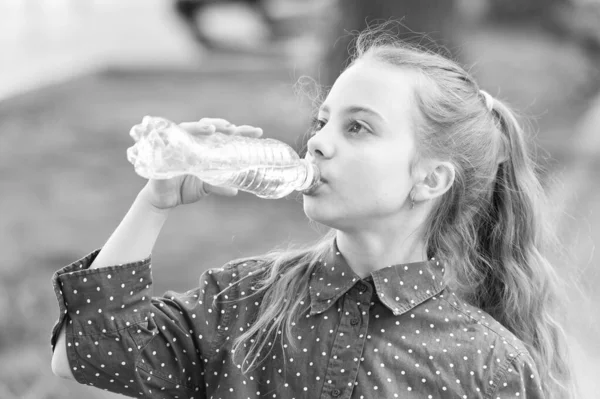 Healthy habits. Healthy and hydrated. Girl care about health and water balance. Girl cute kid hold water bottle. Water balance concept. Drink water while walk. Teach kids about body hydration — Stock Photo, Image