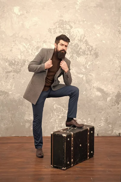 Best travel bags for men. Guy well groomed elegant bearded man and vintage suitcase. Time traveller concept. Vintage inspired design of bag. Retro and vintage. Fashion trend. Accessories for vacation