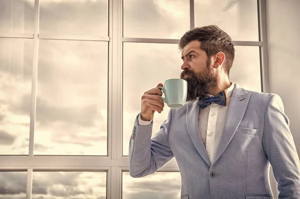 good morning coffee. serious bearded man drink coffee. businessman in formal outfit. modern life. business man at window. future success. morning inspiration. copy space. enjoying morning coffee
