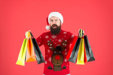 Neredeyse Noel 'de. Aileye hediyeler. Sakallı hippi alışveriş çantası taşır. Noel Baba hediye aldı. Noel hediyeleri. Geyikli yılbaşı kazağı giyen adam. Organize bir müşteri. Kompülsif alıcı. Perakende