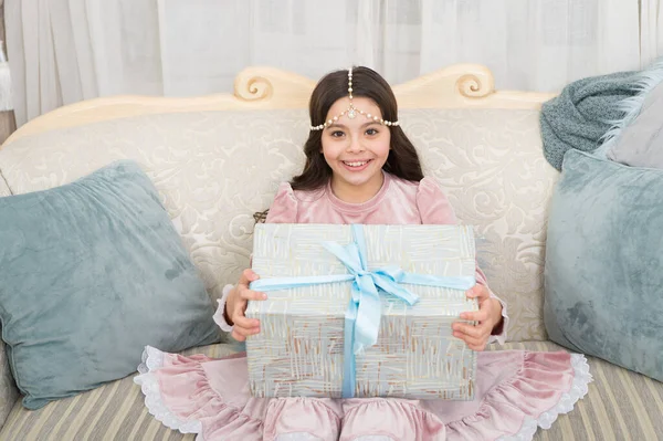 Happy kid opening surprise gift. Delivering happiness. Wait for santa claus. Christmas time. Happy child with present box. Happy new year. Celebrate. Tenderness concept. Making surprise for daughter