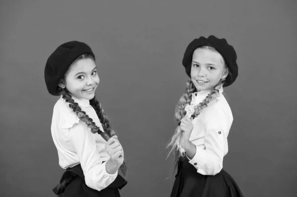 Best friends. Schoolgirls wear formal school uniform. Children beautiful girls long braided hair. Little girls with braids ready for school. School fashion concept. Fancy style. School friendship — Stock Photo, Image