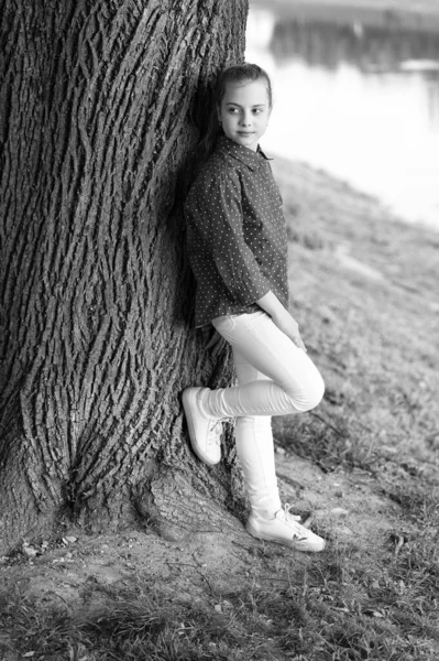 Find peace and relax in nature. Calm and peaceful. Life balance. Peaceful mood. Good vibes only. Girl little cute child enjoy peace and tranquility at tree trunk. Place of power. Peaceful place — Stock Photo, Image