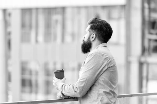 Set up for new day. Daily rituals. Morning coffee concept. Caffeine energy charge. Personal efficiency. Guy bearded hipster enjoying coffee alone. Man drink take away coffee outdoors urban background — Stock Photo, Image