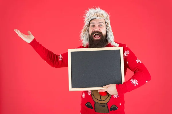 Choose your winter. Happy hipster in winter wear. Bearded man hold empty blackboard. Winter holidays. Christmas and new year activities. Cozy winter wishes, copy space — Stock Photo, Image