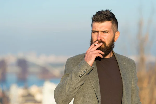 Nicotine abuse. Cigarette smoker. Bearded man smoke nicotine cigarette outdoor. Addiction to nicotine. Smoking habit comes from nicotine dependence Bad habit — Stock Photo, Image