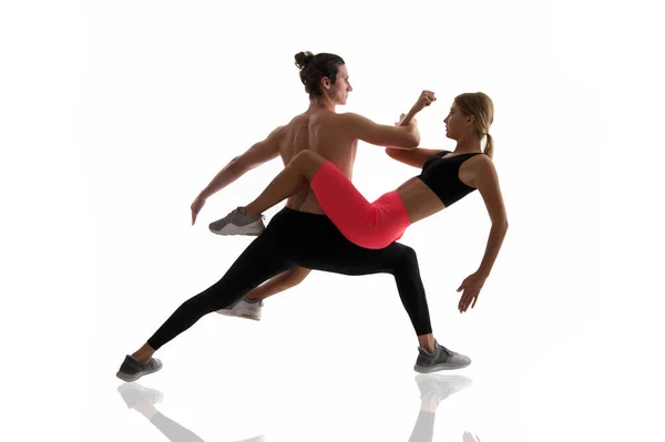 Improving flexibility through pilates training. Couple of athletes training together isolated on white. Athletic training. Physical training activity and sport. Fitness — Stock Photo, Image