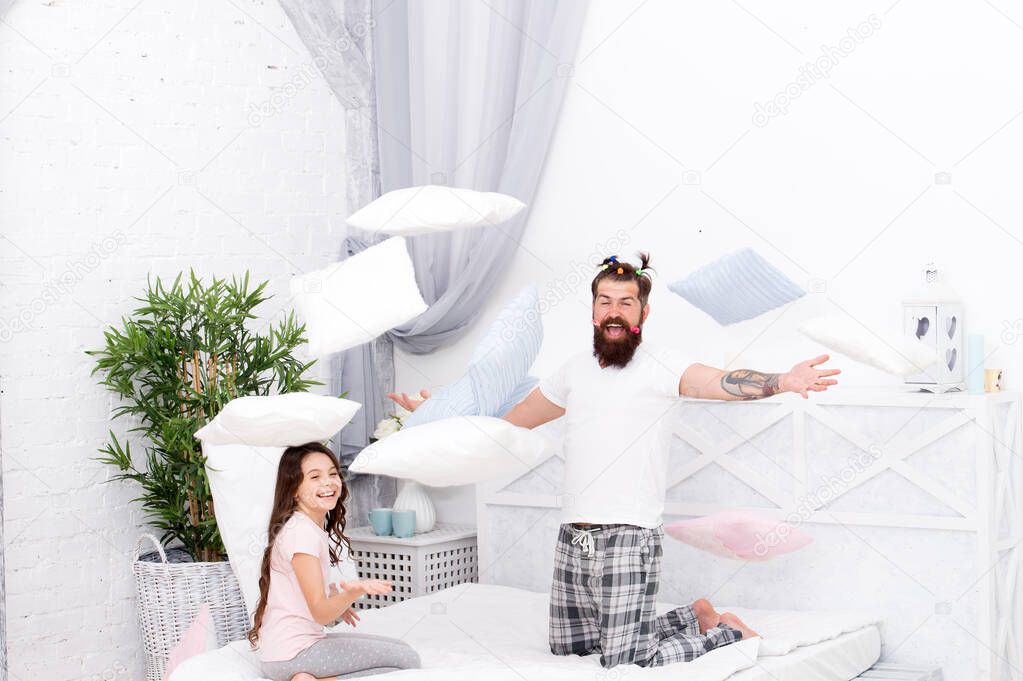 father and daughter having fun. family bonding time. i love my daddy. happy morning together. going crazy. funny pajama party. small girl with bearded father in bed. weekend at home. Just relax