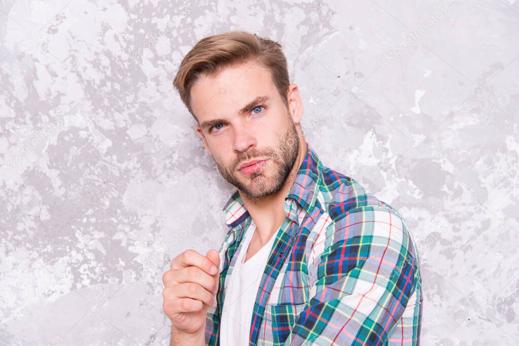Men with well-groomed hair. barbershop concept. sexy guy casual style. macho man grunge background. male fashion spring collection. charismatic student checkered shirt. unshaven man care his look