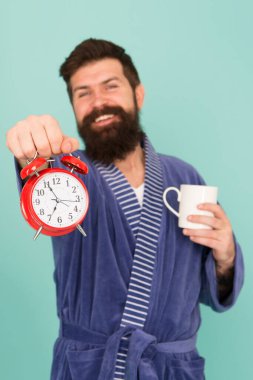 improve my morning routine. hard morning. hipster drink morning coffee. bearded man coffee cup. wakeup time. early wakening feel good. man show time alarm clock. tea time at home. Alarm clock ringing clipart