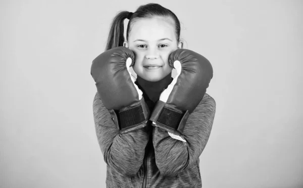 Contrary to stereotype. Boxer child in boxing gloves. Female boxer. Sport upbringing. Boxing provide strict discipline. Girl cute boxer on blue background. With great power comes great responsibility — Stock Photo, Image