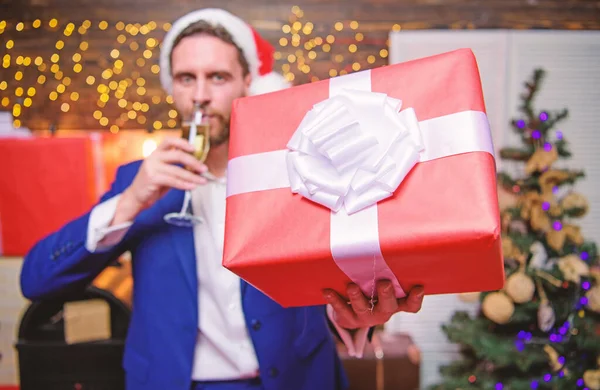 Cheers. Man bearded businessman celebrate new year with glass of champagne and gift box. Happy new year and merry christmas. Cheerful manager formal suit celebrate corporate party. New year party