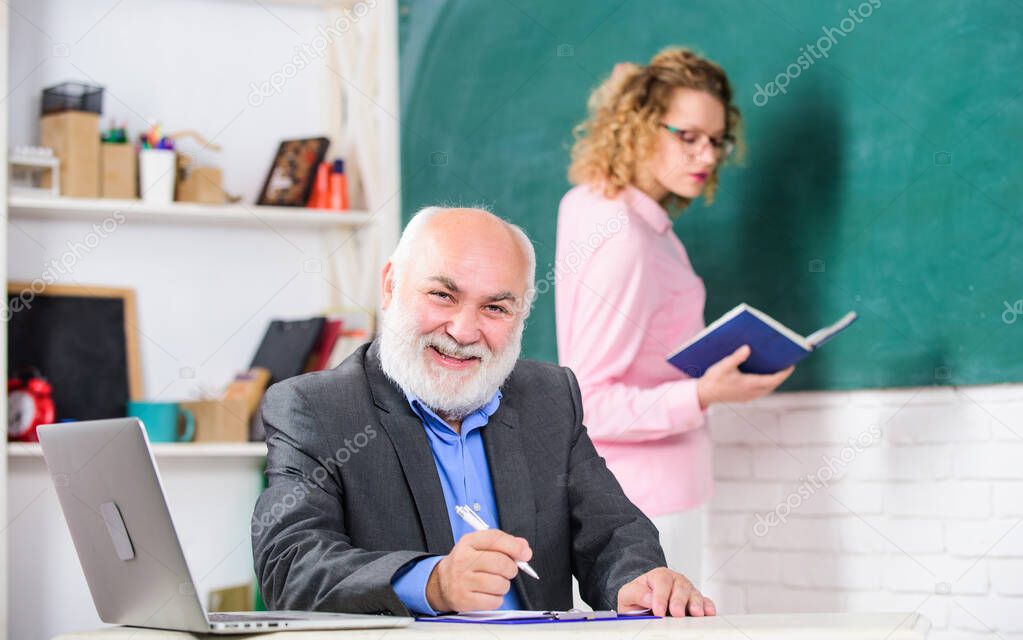 School teacher. pass exam. teachers room. happy senior teacher and woman at school lesson. student and tutor with laptop. Learning Process. student girl with tutor man at blackboard