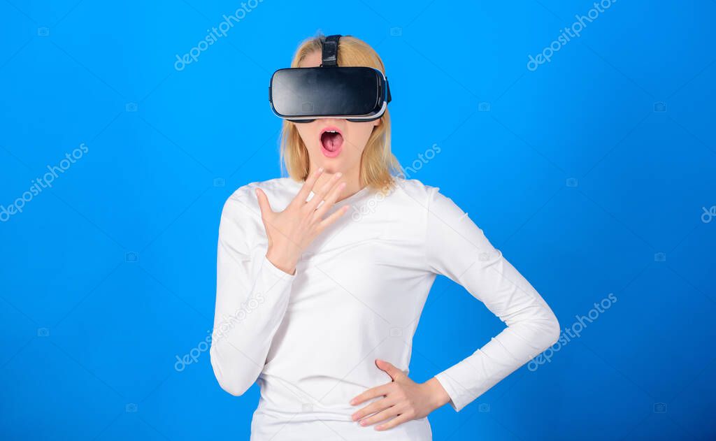 Funny young woman with VR. Cheerful smiling woman looking in VR glasses. Woman using virtual reality headset. Innovation.