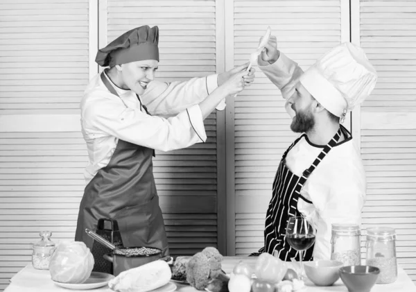 Cooking with your spouse can strengthen relationships. Couple compete in culinary arts. Woman and bearded man culinary partners. Reasons why couples cooking together. Ultimate cooking challenge