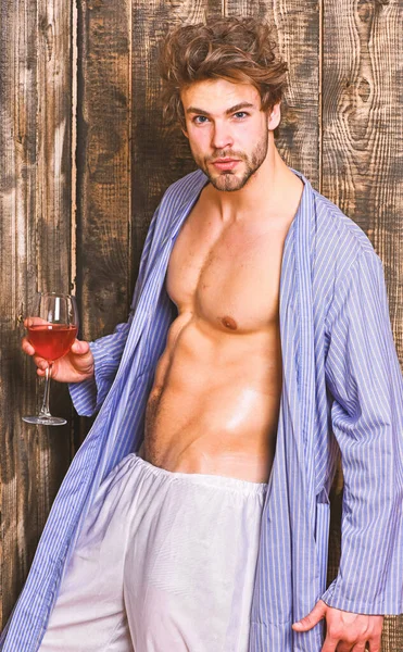 Man sexy chest sweaty skin hold wineglass. Macho tousled hair degustate luxury wine. Drink wine and relax. Erotic and desire concept. Bachelor enjoy wine. Guy attractive relaxing with alcohol drink