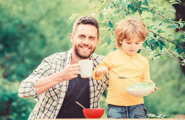 Little boy and dad eating. Nutrition kids and adults. Healthy nutrition concept. Menu for children. Nutrition habits. Family enjoy homemade meal. Healthy breakfast. Father son eat food and have fun — Stock Photo, Image