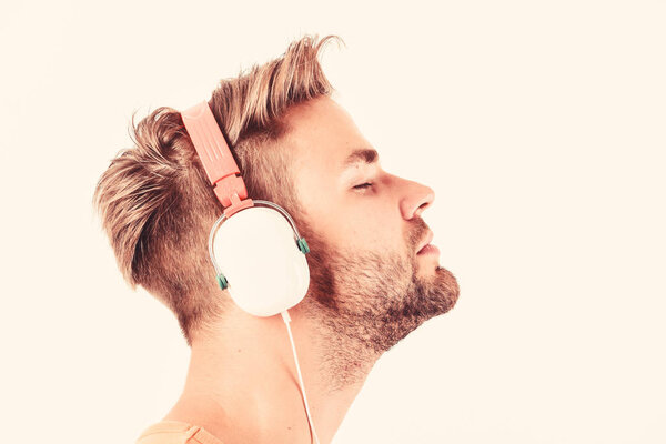 Man listening music headphones white background. Modern technology. Music taste concept. Enjoy perfect music sound headphones. Buy music gadget. Shop store musical accessory gadgets. Sale discount