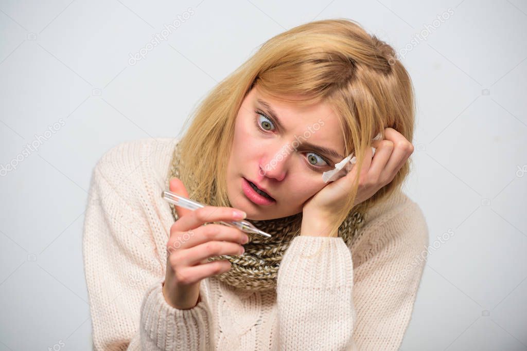 Measure temperature. Break fever remedies. Take temperature and assess symptoms. High temperature concept. Woman feels badly ill sneezing. Girl in scarf hold thermometer and tissue close up