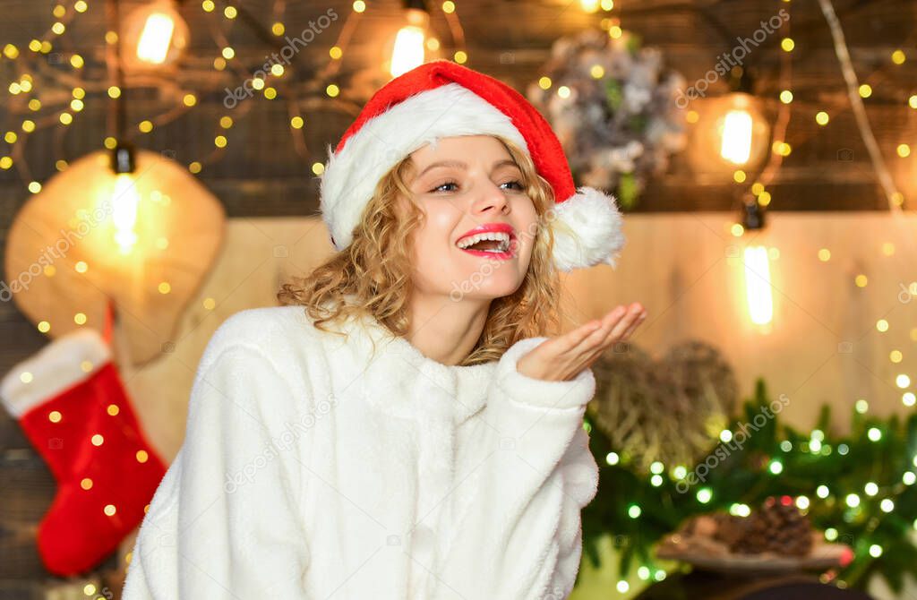 Happy christmas eve. Girl adorable smiling face Santa claus hat enjoy season. Festive mood concept. Do something exciting and crazy to remember the festive with. Festive decorations and accessories