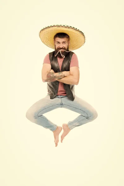 Mexican energy. Mexican party concept. Celebrate traditional mexican holiday. Guy happy cheerful face having fun dancing jumping. Life in motion. Man bearded cheerful guy wear sombrero mexican hat