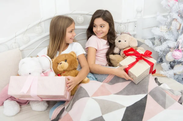 Opening presents on Christmas morning. New Year surprise. Happy small children hold gift boxes. Cute small girls with presents in bed. Wake up and have some fun. Merry Christmas and Happy New Year — Stock Photo, Image