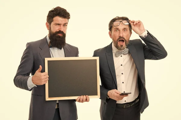 announcement. party invitation. businessmen use phone, copy space. bearded men hold advertisement blackboard. partners celebrate start up business isolated on white. welcome on board announcement