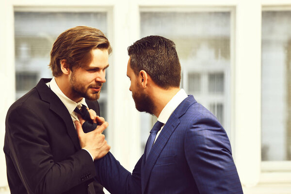 Businessmen fight in suit. Investment risk concept