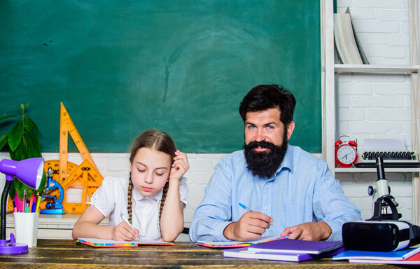Wisdom. daughter study with father. Teachers day. back to school. knowledge day. Home schooling. education child development. bearded man teacher with small girl in classroom