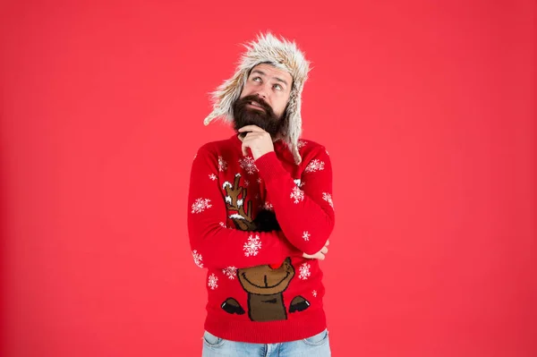 Make christmas wish. Life changing decision. Hipster bearded man wear winter sweater and hat. Happy new year. Winter party outfit. Man thoughtful face expression. Hard decision. Decision making