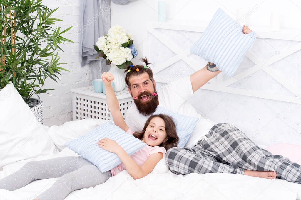 funny pajama party. small girl with bearded father in bed. weekend at home. Happy fatherhood. father and daughter having fun. family bonding time. i love my daddy. happy morning together