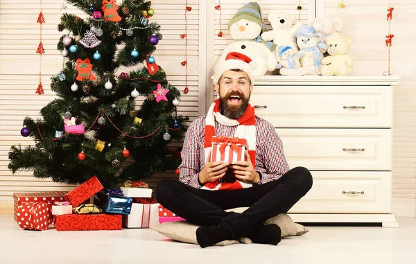 Celebration and gift concept. Man with beard holds present box. — Stock Photo, Image