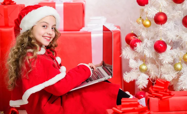 Online santa. Send message to santa claus. Christmas and new year holiday. Writing letter to santa claus. Winter tradition. Kid cute girl writing email letter on laptop. Modern letter for santa claus