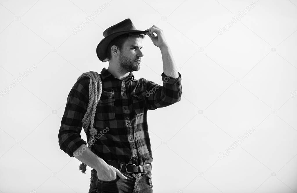 far far away. Vintage style man. Wild West retro cowboy. man checkered shirt on ranch. wild west rodeo. Thoughtful man in hat relax. cowboy with lasso rope. Western. western cowboy portrait