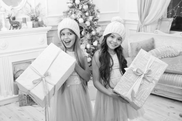 delivery christmas gifts. happy new year. happy little girls sisters celebrate winter holiday. christmas time. Family holiday. little children girl with xmas present. Holiday program