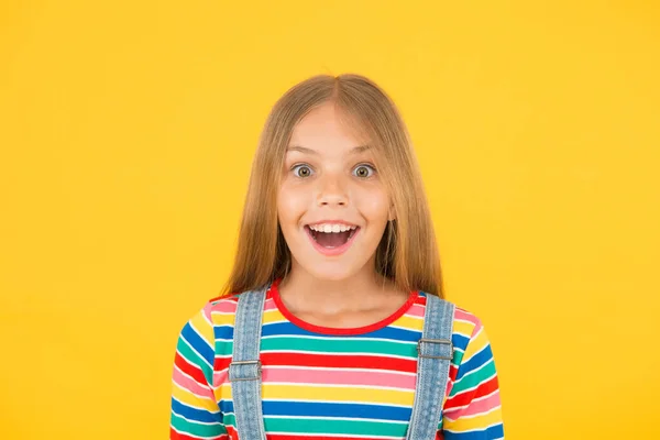 Happy childrens day. childhood happiness. cheerful hipster girl colorful clothes. optimist concept. small girl yellow background. summer kid fashion. kid positive mood. Child happiness portrait — ストック写真