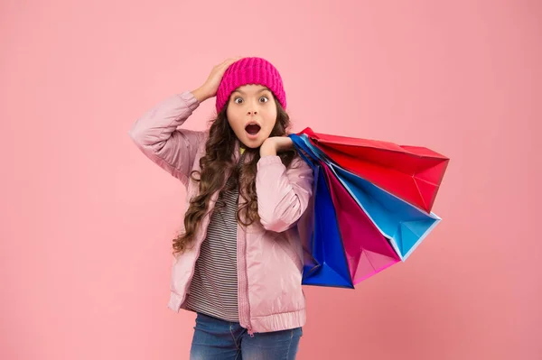 Bags perfect for carrying all epic shopping. Shocked shopper hold shopping bags. Little child with paper bags. Small girl carry holiday purchases in colorful bags. Autumn sale and discount — Stock Photo, Image