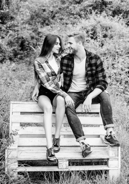 Boyfriend and girlfriend in love. Love and romance concept. Family weekend. Romantic date in park. Couple in love sit on bench. Youth hang out. Summer vacation. Enjoying nice weekend together