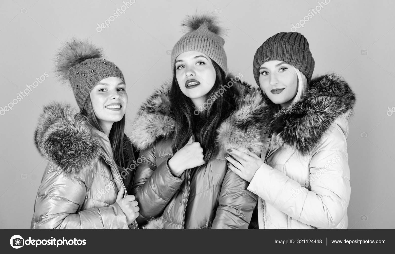 It is cold outside. women in padded warm coat. family christmas. happy  winter holidays. Friendship. flu and cold. seasonal shopping. winter  clothing fashion. faux fur down jacket. girls in beanie Stock Photo