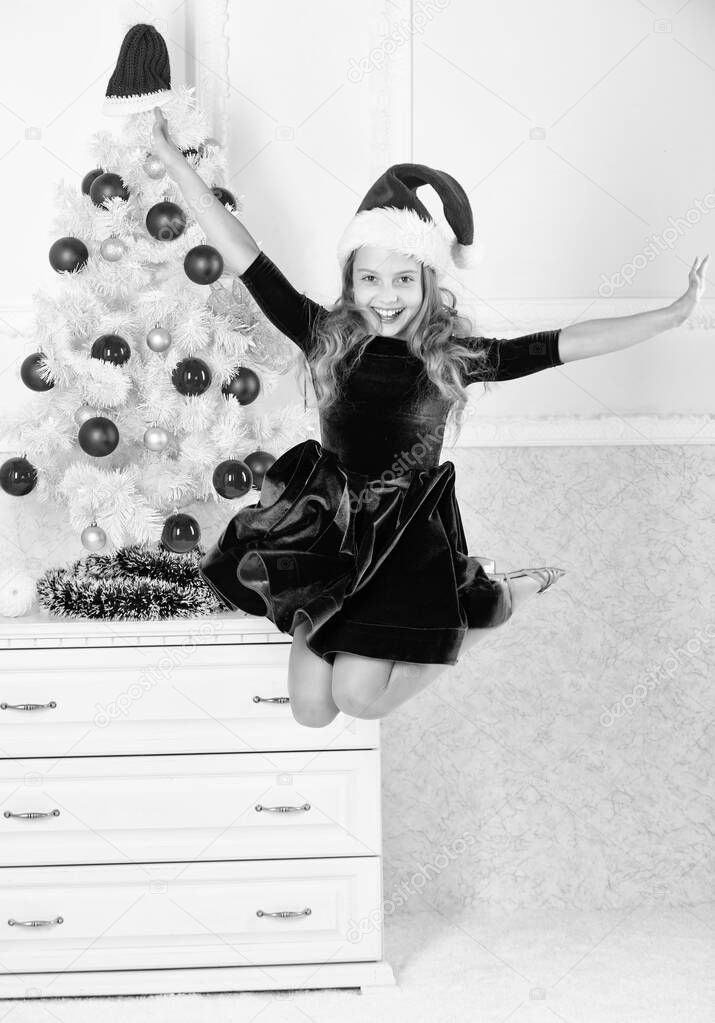 Day we have waited for all year finally here. Girl excited about christmas jump mid air. Child emotional cant stop her feelings. Celebrate christmas concept. Girl in dress jumping. It is christmas