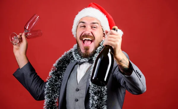 Vállalati karácsonyi buli. Kreatív tószt. Egészségedre! Csatlakozz az irodai bulihoz. Ünnepeljük az új évet. Karácsonyi buli. Vállalati parti ötletek. Férfi szakállas hipster viselni Mikulás kalap tartsa pezsgő üveg — Stock Fotó