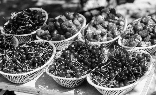 Summer harvest. Red ripe berries. Juicy berries from garden. Buy fresh fruits. Organic berries. Healthy delicious snack. Homegrown berries. Cherries and strawberries in baskets for sell. Farm market